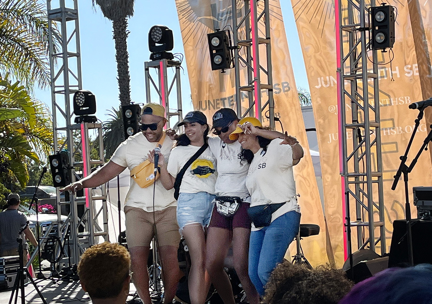 Group of four young people, two girls and two boys, standing on the Juneteenth stage