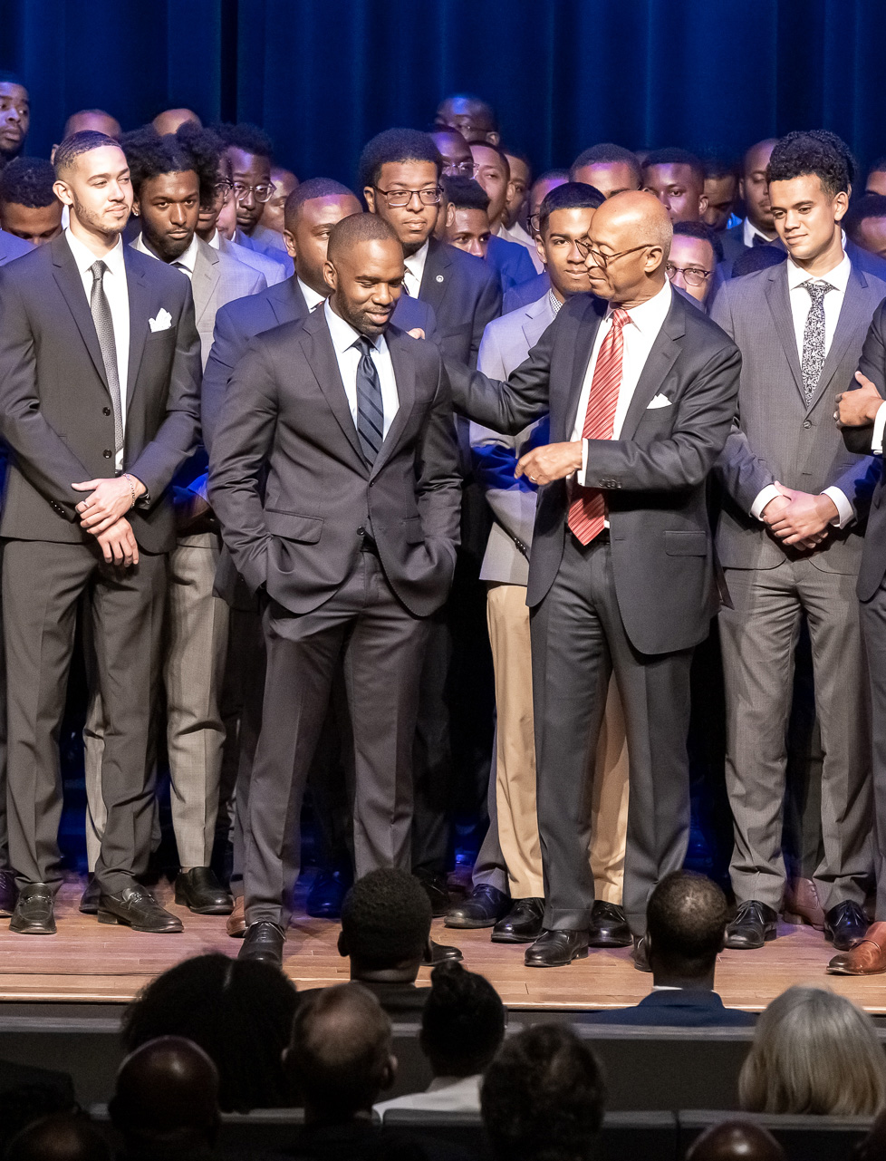 Group of young scholars all dressed up on stage