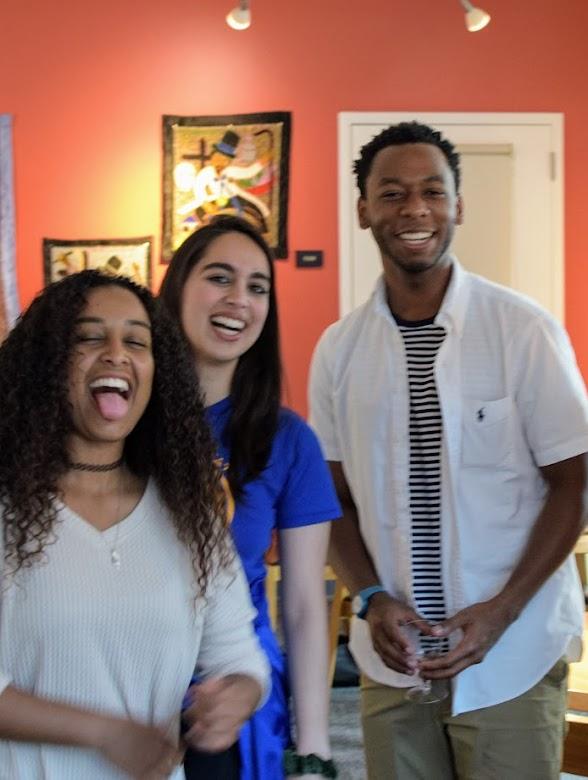 Three students smiling at camera, one boy and two girls
