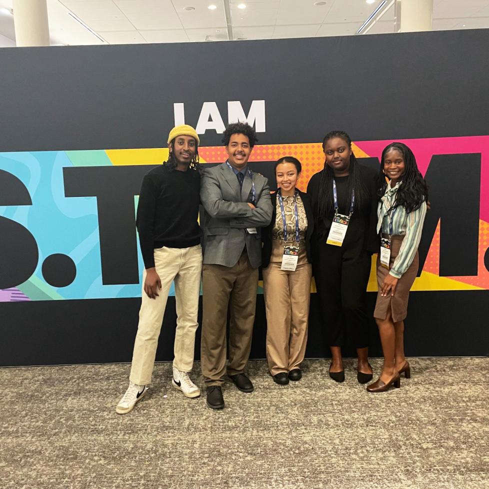 Group of NSBE students posing in front of STEM sign